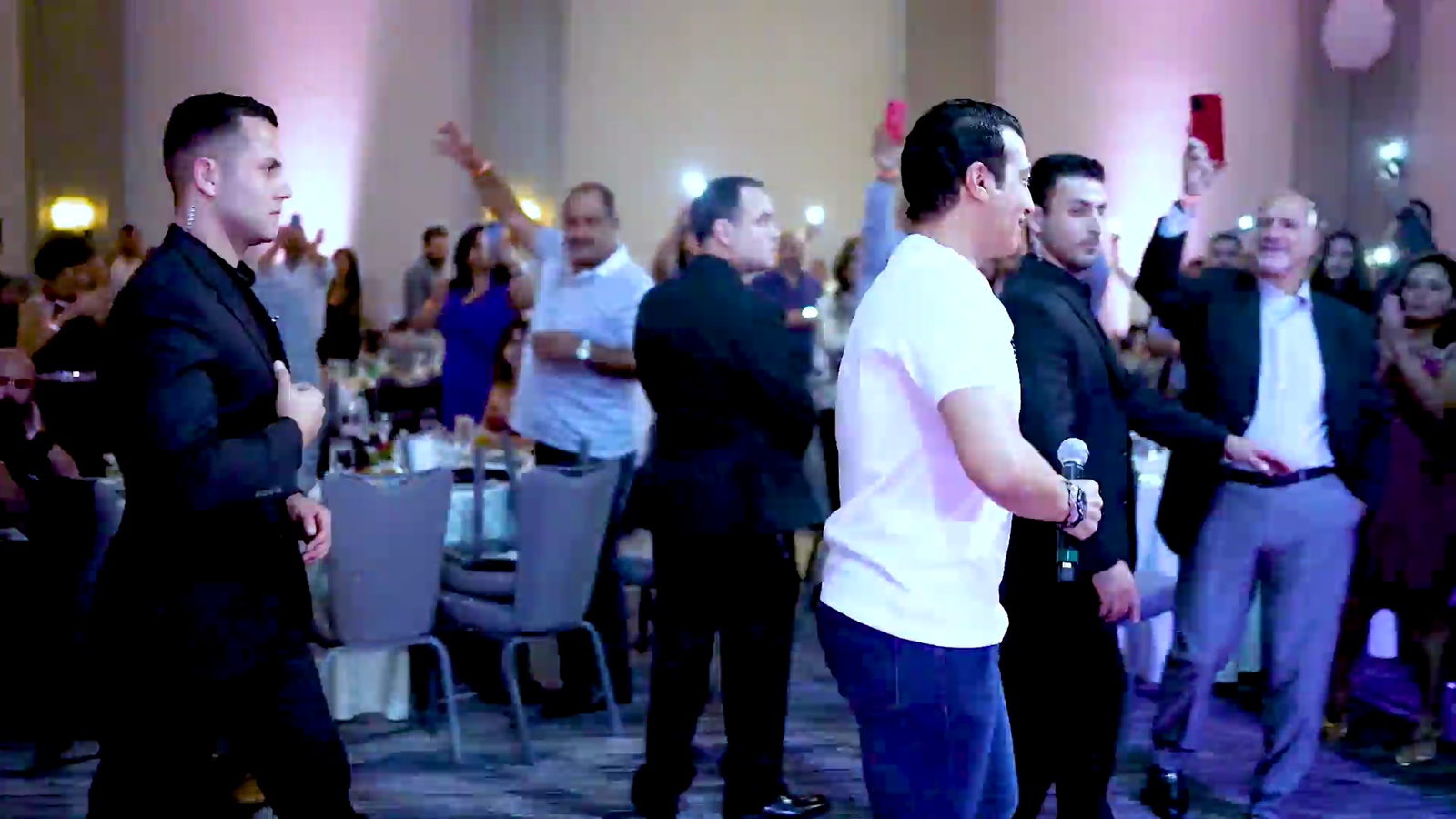 Security personnel in suits monitoring a lively event, ensuring safety and focus amidst a celebratory atmosphere, representing Mayer Security Services' commitment to professional protection.