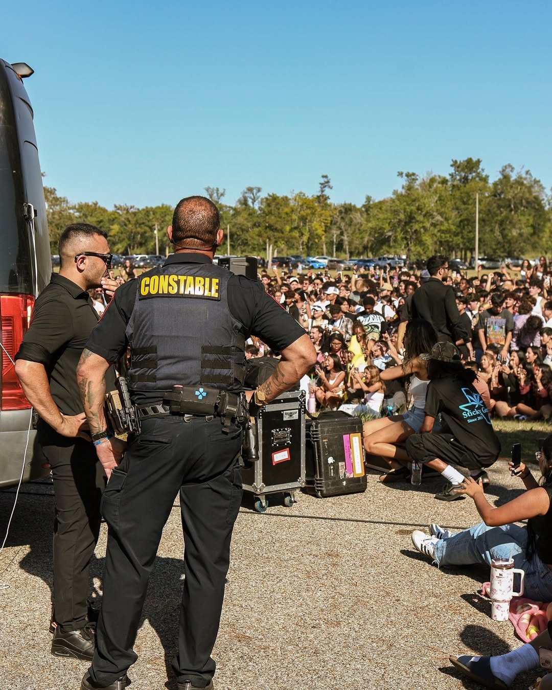 Security personnel managing crowd at Daniel Caesar's pop-up concert, showcasing Mayer Security Services' executive protection strategies in a dynamic outdoor setting.
