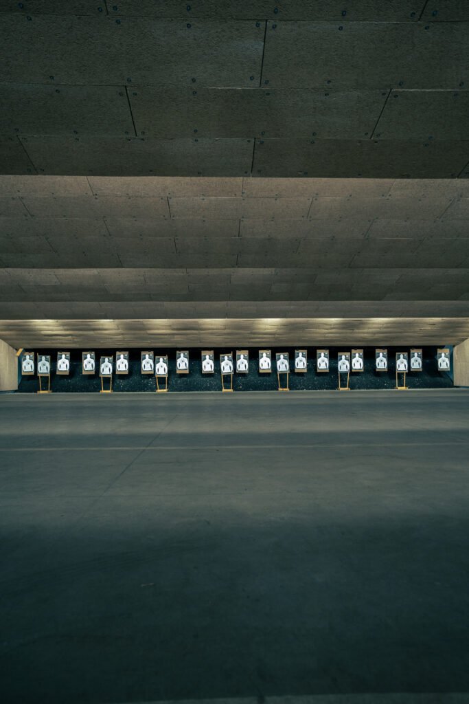 Indoor shooting range with silhouette targets set up for Achilles Heel Tactical carbine training