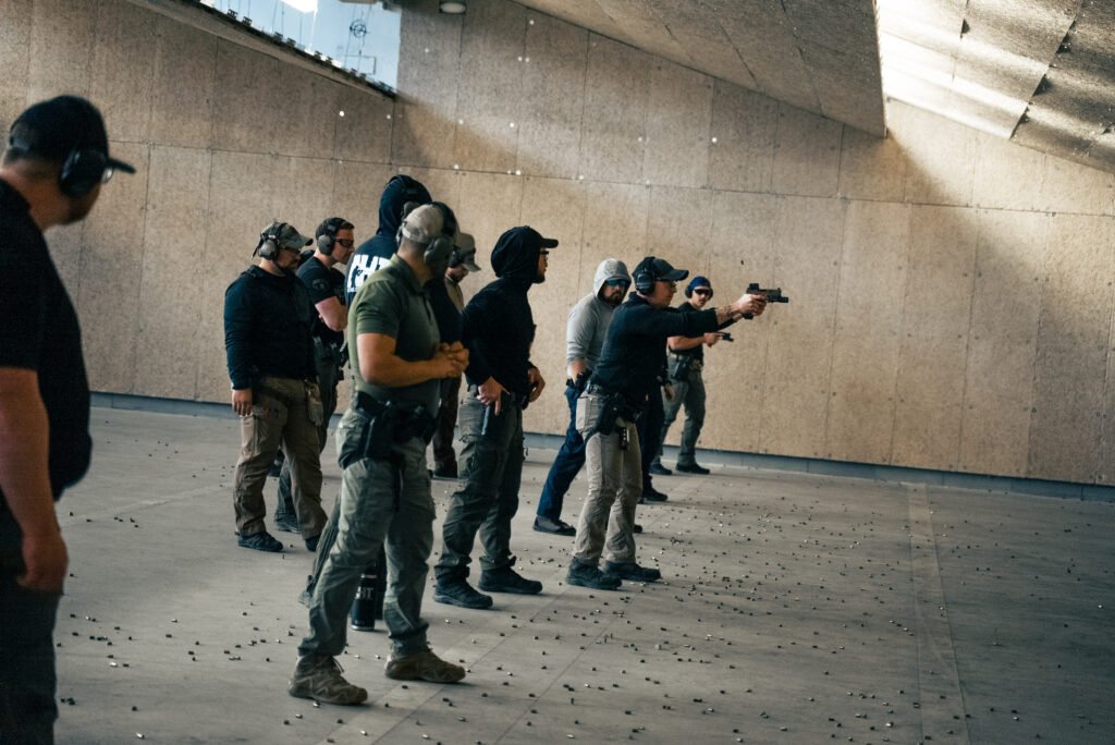 AHT instructor observing and correcting students during pistol training iterations